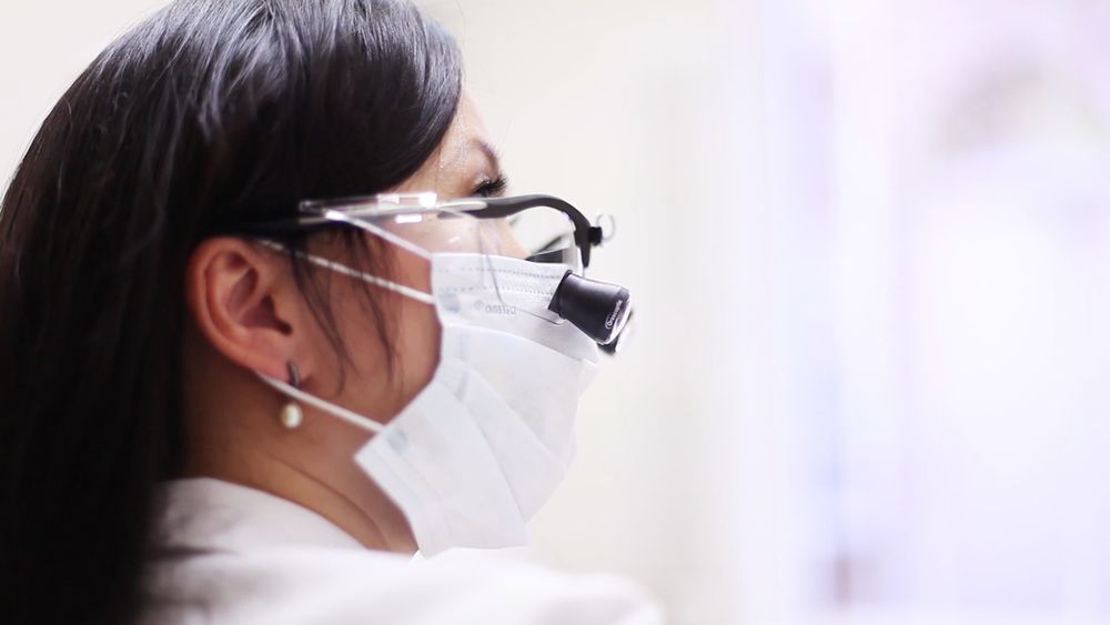 A Story Dental dentist at work, mask and loupes on