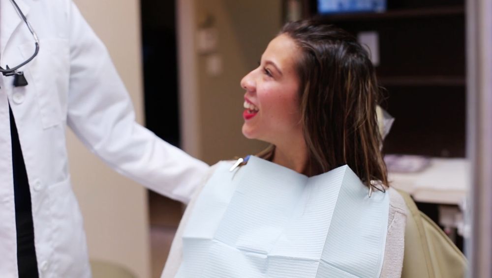 A patient smiling in the chair at Story Dental