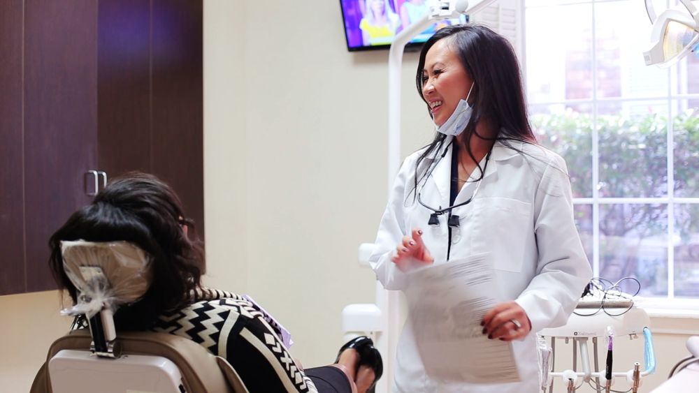 A dentist talking through treatment with a patient at Story Dental